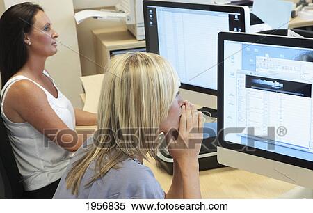 a young woman sits at her computer staring at her computer screen; south shields tyne and wear england View Large Photo Image Stock Photography - a young woman sits at her computer staring at her computer screen; south shields tyne and wear england. Fotosearch