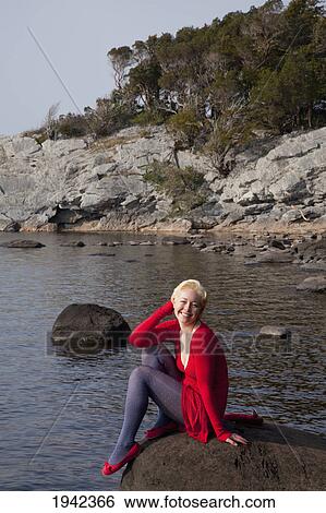 A Young Woman Sits On A Large Rock On Muckross Lake; Killarney County Kerry Ireland View Large Photo Image Stock Photograph - A Young Woman Sits On A Large Rock On Muckross Lake; Killarney County Kerry Ireland. Fotosearch