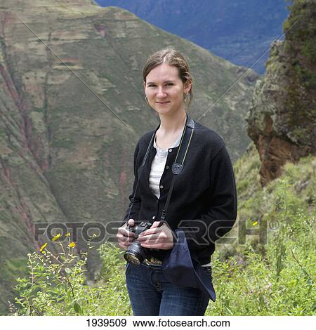 Stock Photo - A Young Woman With Her Camera At The Archaeological Park Of Pisac; Peru. Fotosearch