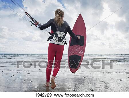 A Young Woman With Her Equipment For Kite Surfing On Dos Mares Beach; Tarifa Cadiz Andalusia Spain View Large Photo Image Stock Photo - A Young Woman With Her Equipment For Kite Surfing On Dos Mares Beach; Tarifa Cadiz Andalusia Spain. Fotosearch