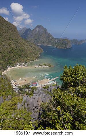 Aerial View Of Limestone Spires Over Coastal Village; El Nido, Palawan, Philippines View Large Photo Image Stock Photo - Aerial View Of Limestone Spires Over Coastal Village; El Nido, Palawan, Philippines. Fotosearch