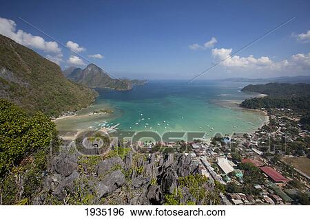 Stock Photograph - Aerial View Of Limestone Spires Over Coastal Village; El Nido, Palawan, Philippines. Fotosearch