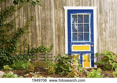 Stock Photograph - blue door and a garden; st. etienne-des-gres quebec canada. Fotosearch