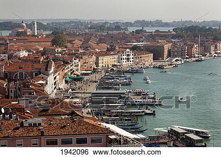 Stock Photograph - Boats And Buildings Along The Lagoon; Venice Italy. Fotosearch