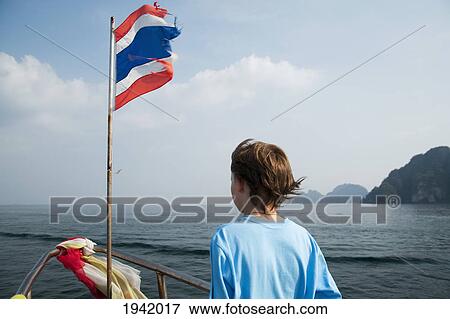 Boy On Boat With Flag Of Thailand; Phi Phi Island Thailand View Large Photo Image Stock Photo - Boy On Boat With Flag Of Thailand; Phi Phi Island Thailand. Fotosearch