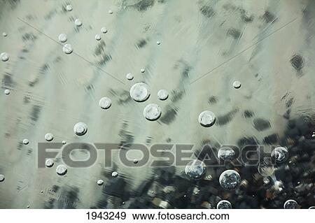 Bubbles Beneath The Ice In A Glacial Lake; Banff Alberta Canada View Large Photo Image Stock Photo - Bubbles Beneath The Ice In A Glacial Lake; Banff Alberta Canada. Fotosearch