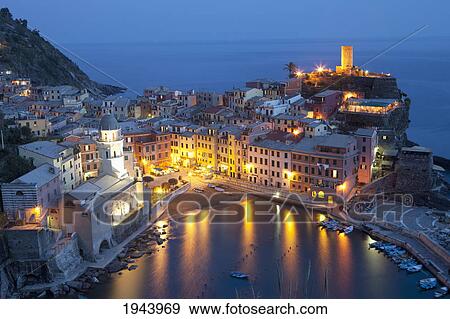Stock Photo - Buildings Along The Waterfront Illuminated At Night; Vernazza Liguria Italy. Fotosearch