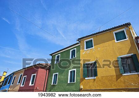 Stock Image - Buildings In A Row Painted All Different Bright Colors; Burano Venezia Italy. Fotosearch