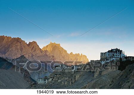 Stock Photo - Buildings On The Edge Of Rock Ledges Beside The Mountains; Lamayuru Ladakh India. Fotosearch