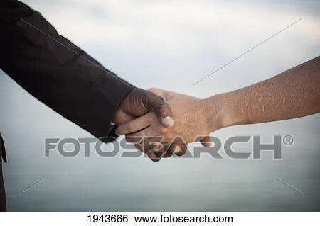 Stock Photograph - Businessmen Shaking Hands; South Caicos Turks And Caicos Islands. Fotosearch
