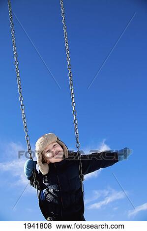 Child Swinging On A Swing; Spruce Grove Alberta Canada View Large Photo Image Stock Photo - Child Swinging On A Swing; Spruce Grove Alberta Canada. Fotosearch