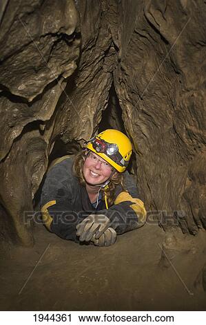 Stock Image - crawling through a cave in grotto mountain; canmore alberta canada. Fotosearch