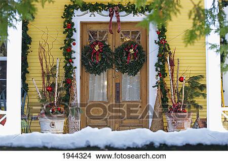 Picture - doors of a house decorated for christmas; knowlton quebec canada. Fotosearch