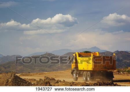 Dump Truck Laden With Earth Driving On Construction Site; Malaga Province Spain View Large Photo Image Stock Photo - Dump Truck Laden With Earth Driving On Construction Site; Malaga Province Spain. Fotosearch