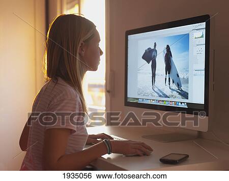 Stock Photograph - Girl Staring At Her Computer Monitor. Fotosearch
