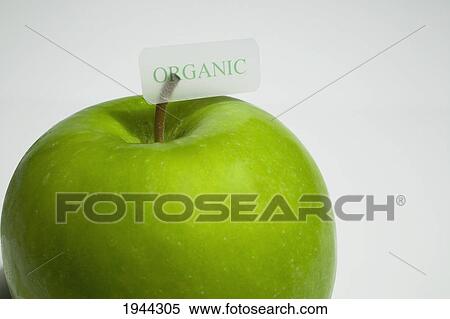 Stock Photography - granny smith apple with an organic label; waterloo quebec canada. Fotosearch