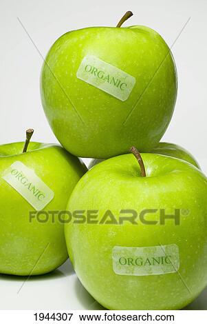 Stock Photo - granny smith apples in a pile labeled organic; waterloo quebec canada. Fotosearch