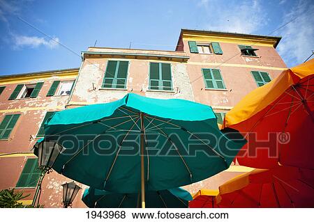 Stock Photo - Green And Yellow Patio Umbrellas Beside A Building; Vernazza Liguria Italy. Fotosearch