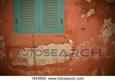 Stock Image - Green Shutters On A Wall With Peeling Paint; Dakar Senegal. Fotosearch