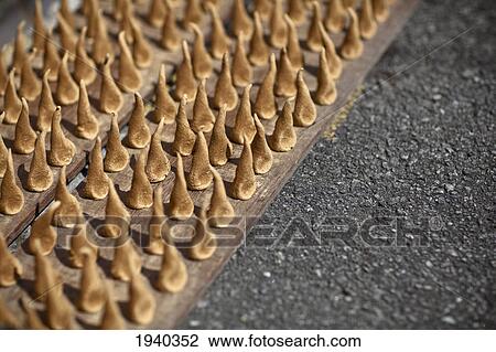 Stock Image - Handmade Sandalwood Incense Dries In The Sun On The Street Side; Penang Malaysia. Fotosearch