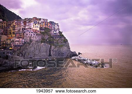 Stock Photo - Houses On A Rock Ledge Along The Coast; Manarola Liguria Italy. Fotosearch