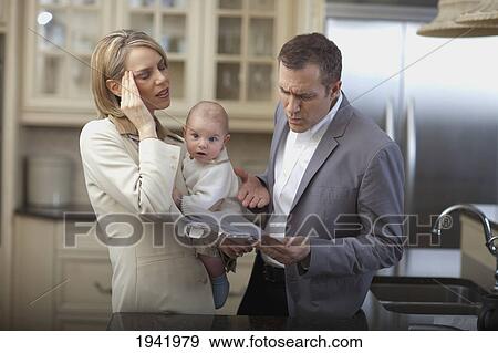 Husband And Wife With Baby Stressing Over Household Bills; Jordan Ontario Canada View Large Photo Image Stock Photo - Husband And Wife With Baby Stressing Over Household Bills; Jordan Ontario Canada. Fotosearch