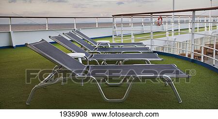Stock Photo - Lounge Chairs Sitting On Green Artificial Turf On The Deck Of The Silver Shadow Cruise Ship. Fotosearch