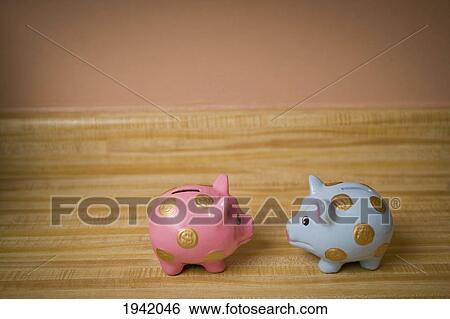 Stock Photograph - Male And Female Piggy Banks In Discussion. Fotosearch