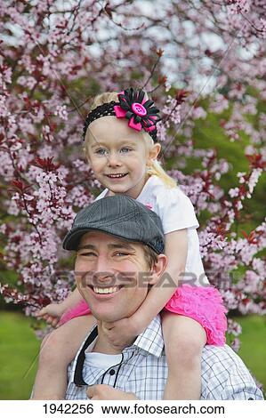 Man Carrying His Daughter On His Shoulders Through The Park In Spring; Portland Oregon View Large Photo Image Stock Photograph - Man Carrying His Daughter On His Shoulders Through The Park In Spring; Portland Oregon. Fotosearch