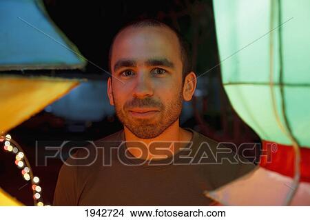 Picture - Man Reflects Thoughtfully In Glow Of Chinese Lanterns; Chiang Mai Thailand. Fotosearch