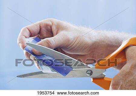 man's hand holding scissors and about to cut up his credit cards; torremolinos malaga andalusia spain View Large Photo Image Picture - man's hand holding scissors and about to cut up his credit cards; torremolinos malaga andalusia spain. Fotosearch
