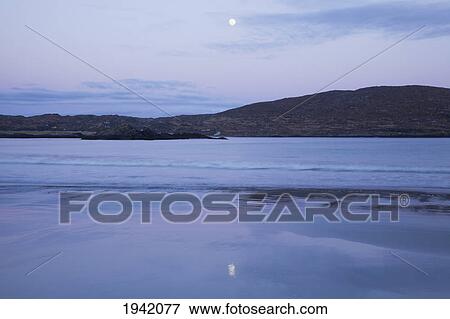 Stock Photo - Moonrise On Derrynane Beach Near Chaerdaniel; County Kerry Ireland. Fotosearch
