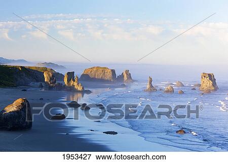 morning light adds beauty to fog covered rock formations at bandon state park; bandon oregon united states of america View Large Photo Image Stock Photo - morning light adds beauty to fog covered rock formations at bandon state park; bandon oregon united states of america. Fotosearch