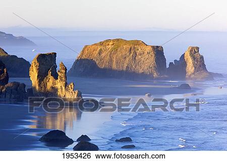 Stock Photograph - morning light adds beauty to fog covered rock formations at bandon state park; bandon oregon united states of america. Fotosearch