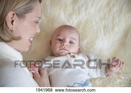 Stock Photo - Mother And Baby On Carpet; Jordan Ontario Canada. Fotosearch