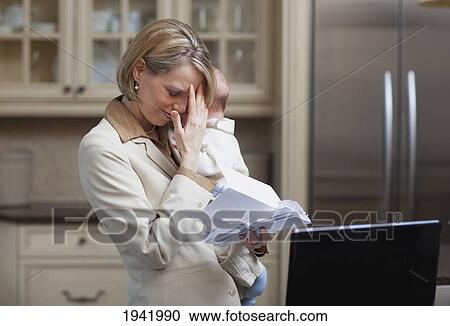 Mother With Baby Stressing Over Household Bills; Jordan Ontario Canada View Large Photo Image Stock Image - Mother With Baby Stressing Over Household Bills; Jordan Ontario Canada. Fotosearch