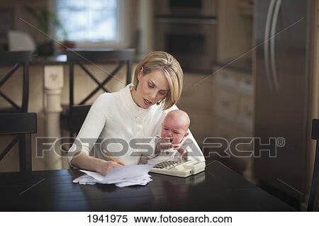 Mother With Baby Stressing Over Household Finances; Jordan Ontario Canada View Large Photo Image Stock Photography - Mother With Baby Stressing Over Household Finances; Jordan Ontario Canada. Fotosearch