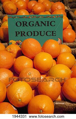 Stock Image - oranges with a sign labeled organic produce; waterloo quebec canada. Fotosearch