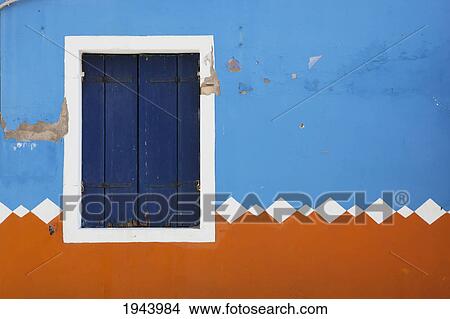 Paint Peeling Off Of A Decorative Exterior Wall And A Closed Shutters On A Window; Burano Venezia Italy View Large Photo Image Picture - Paint Peeling Off Of A Decorative Exterior Wall And A Closed Shutters On A Window; Burano Venezia Italy. Fotosearch