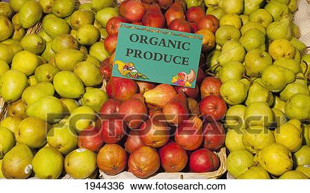 Stock Photograph - pears on display with a sign labeled organic produce; waterloo quebec canada. Fotosearch