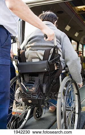 Person Helping Woman In Wheelchair Onto A Bus; Bolton Lancashire England View Large Photo Image Stock Image - Person Helping Woman In Wheelchair Onto A Bus; Bolton Lancashire England. Fotosearch