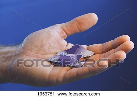 Stock Image - pieces of cut up credit card resting in a man's hand; torremolinos malaga andalusia spain. Fotosearch