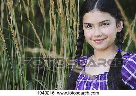 Portrait Of A Girl With Long Braids Standing In Wheat; Troutdale Oregon United States Of America View Large Photo Image Stock Photograph - Portrait Of A Girl With Long Braids Standing In Wheat; Troutdale Oregon United States Of America. Fotosearch