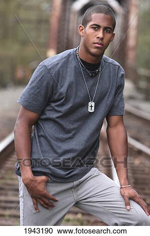 Portrait Of A Teenage Boy Standing On Railroad Tracks; Troutdale Oregon United States Of America View Large Photo Image Stock Image - Portrait Of A Teenage Boy Standing On Railroad Tracks; Troutdale Oregon United States Of America. Fotosearch