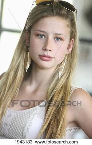 Stock Image - Portrait Of A Teenage Girl With Gold Leaf Earrings And Sunglasses; Troutdale Oregon United States Of America. Fotosearch