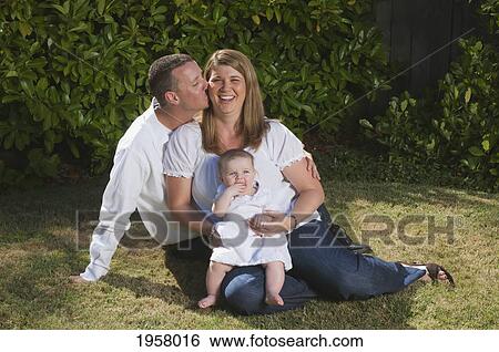 portrait of a young couple with a baby on the grass; moraga california united states of america View Large Photo Image Stock Photograph - portrait of a young couple with a baby on the grass; moraga california united states of america. Fotosearch