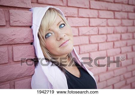 Portrait Of A Young Woman Leaning Against A Brick Wall; Edmonton Alberta Canada View Large Photo Image Stock Photo - Portrait Of A Young Woman Leaning Against A Brick Wall; Edmonton Alberta Canada. Fotosearch