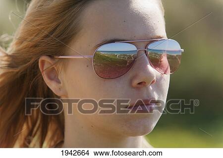 Portrait Of A Young Woman Wearing Sunglasses With The Landscape Reflected In Them; Tarifa Cadiz Andalusia Spain View Large Photo Image Picture - Portrait Of A Young Woman Wearing Sunglasses With The Landscape Reflected In Them; Tarifa Cadiz Andalusia Spain. Fotosearch