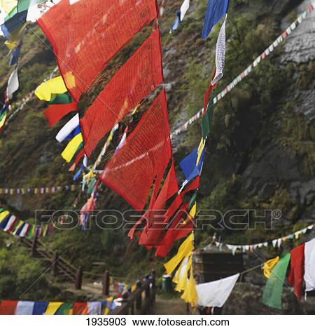 Stock Image - Prayer Flags Hanging Over A Wooden Walkway At Tiger's Nest Monastery; Paro Valley, Taktsang, Bhutan. Fotosearch