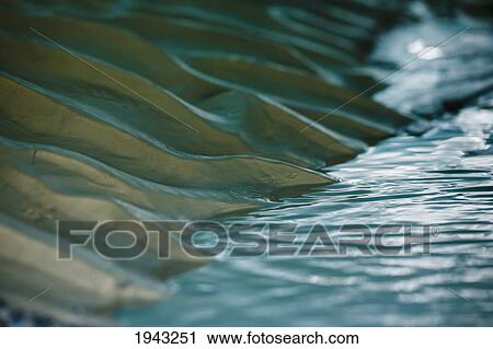Ripples In Sand And Water Beneath A Melting Glacier; Banff Alberta Canada View Large Photo Image Stock Image - Ripples In Sand And Water Beneath A Melting Glacier; Banff Alberta Canada. Fotosearch